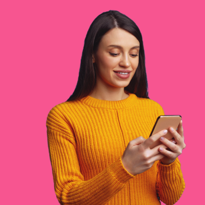 A smiling woman looking at her phone